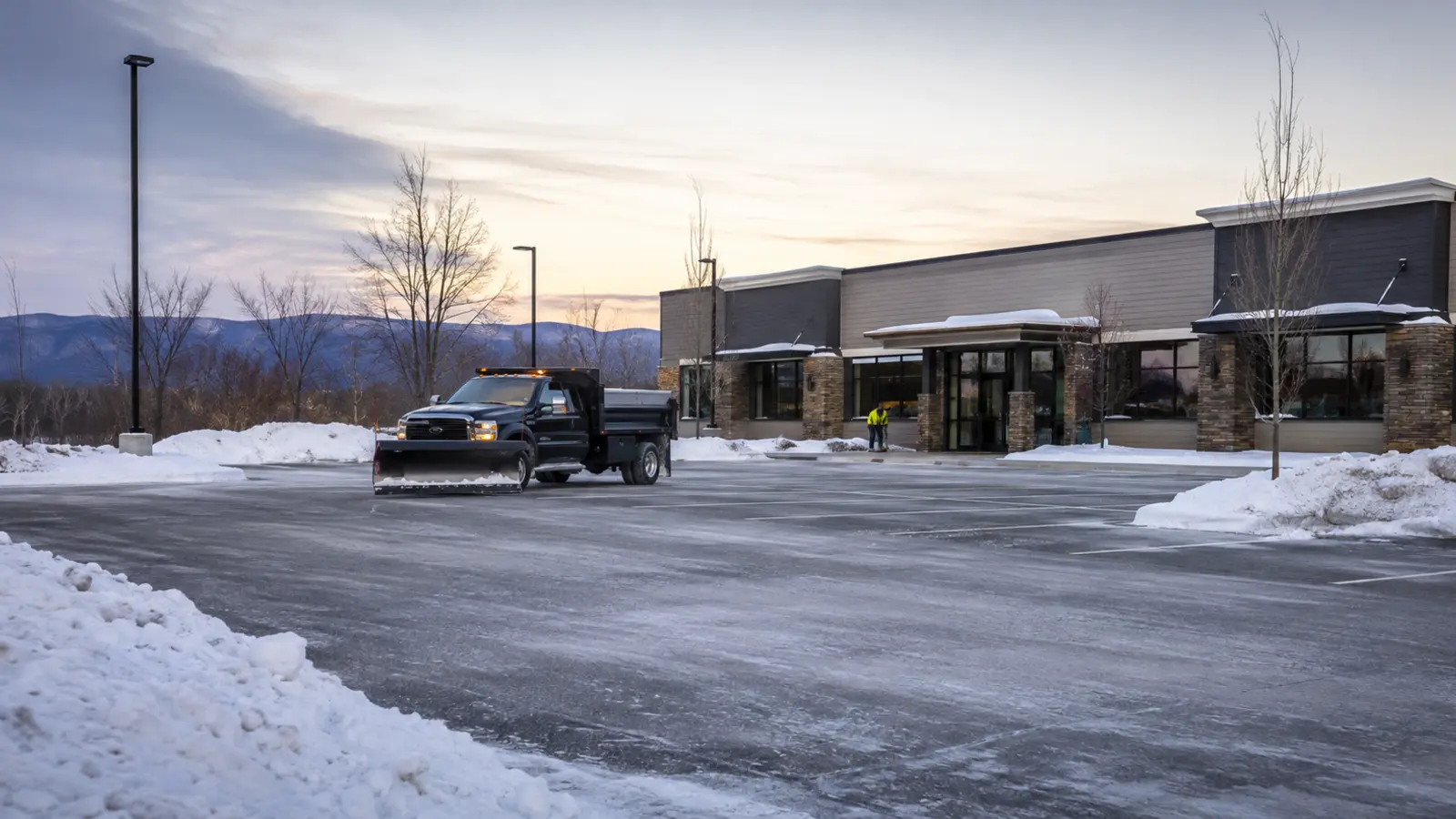 Cleared commercial lot with organized snow storage