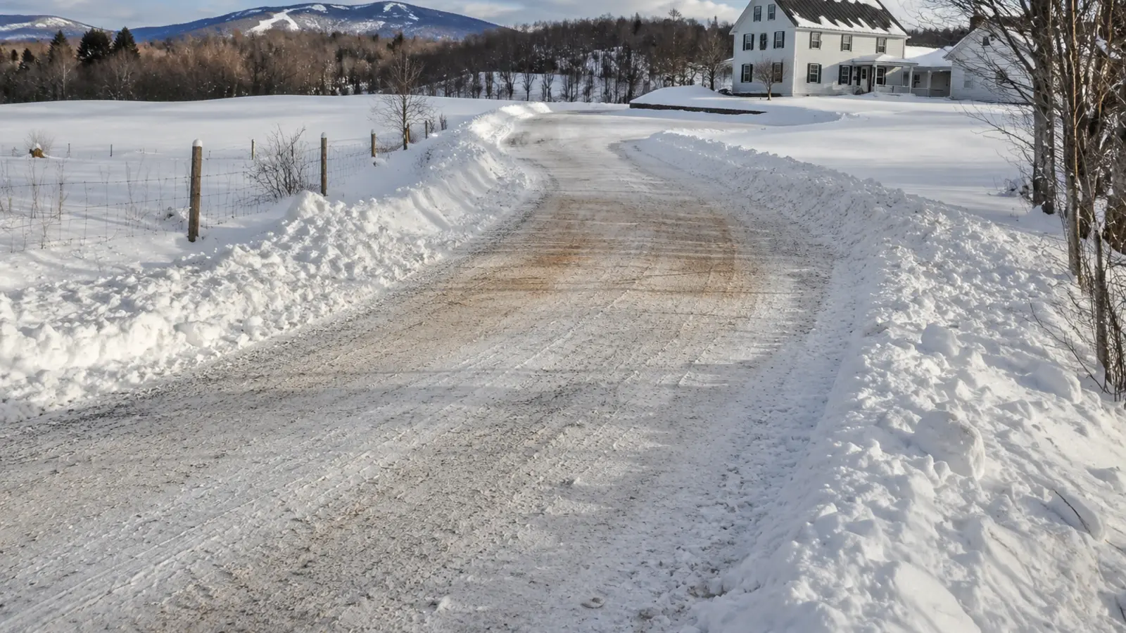 Cleared rural driveway with a marked travel lane